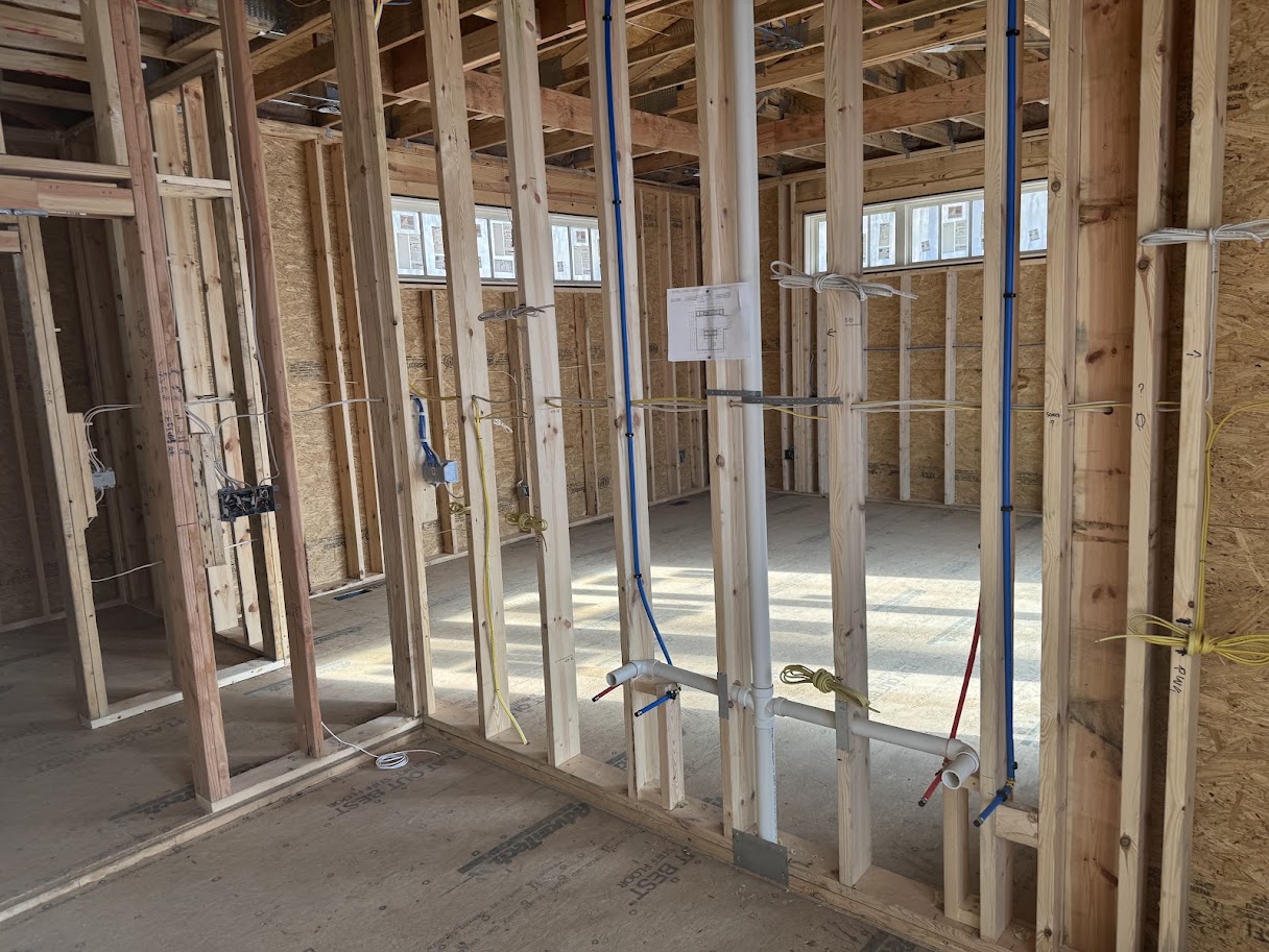 Residential construction framing with plumbing and electrical work carefully planned before finishes